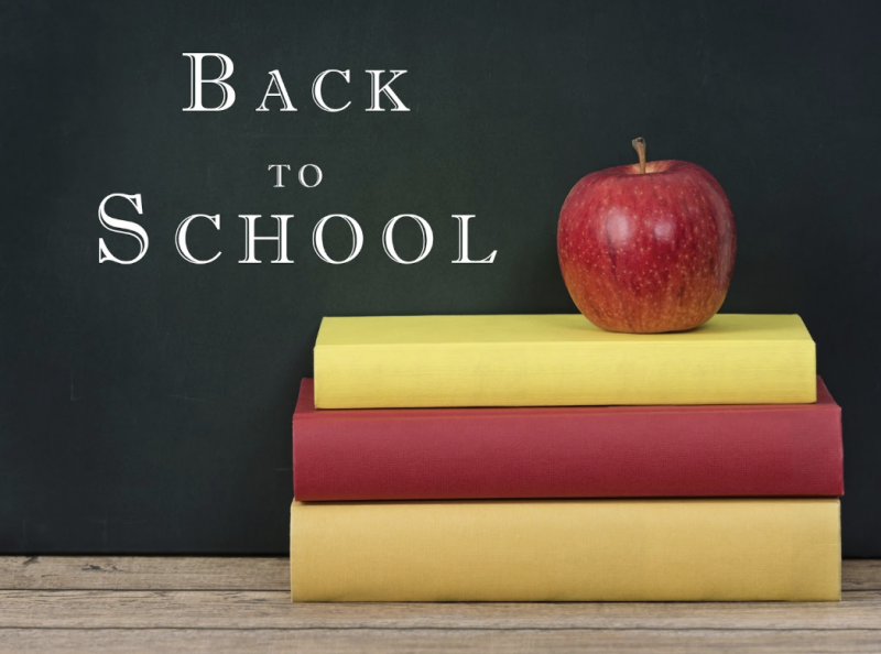 Blackboard with books and an apple back to school