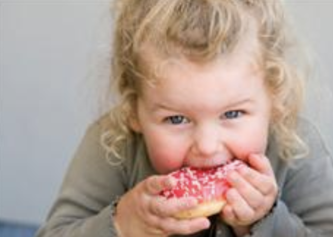 Toddler girl eating watermelon