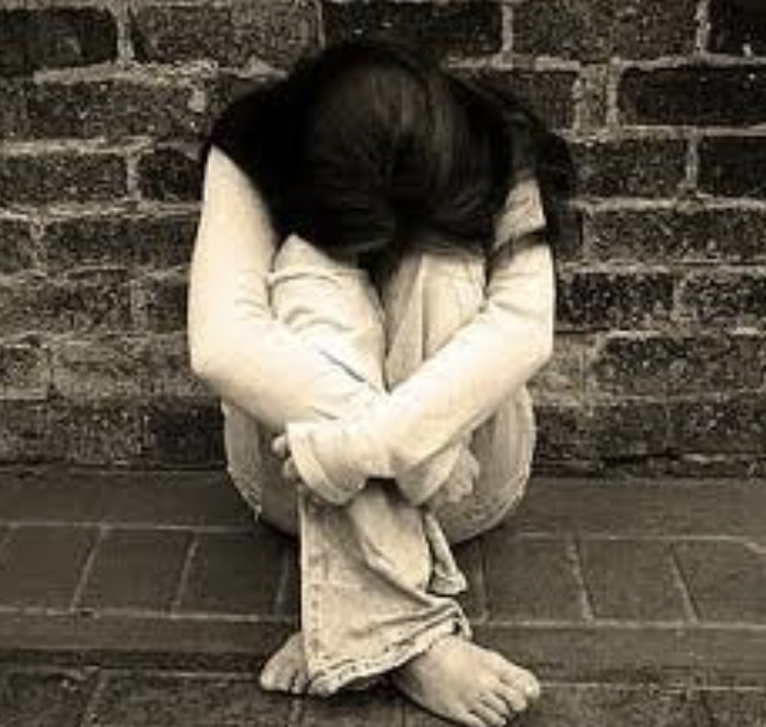 Young woman with head down to her knees