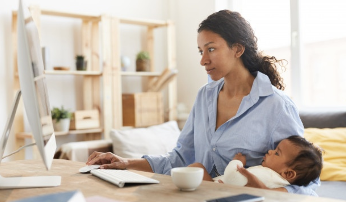 African-American mom on computer with baby in arms - Being an Entrepreneur