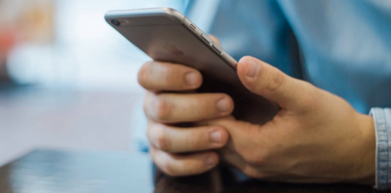 Give them credit - Boy's hand holding smartphone