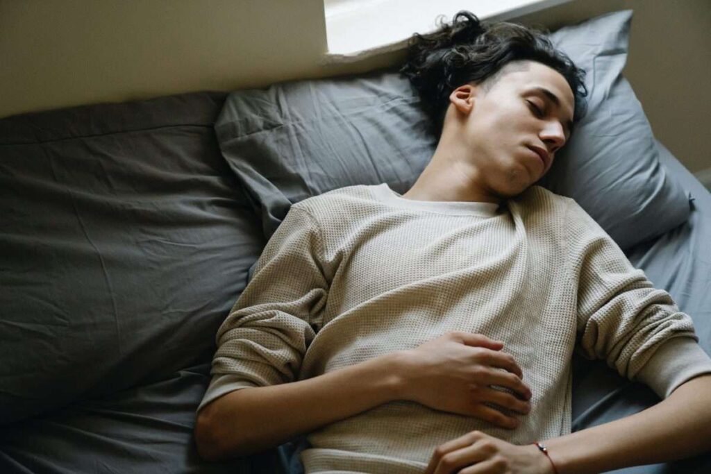 Young man sleeping in bed