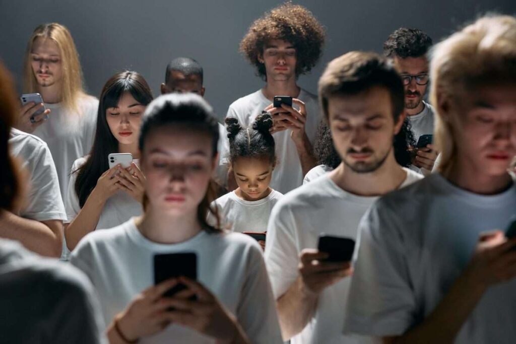 Photo of People Engaged on their Phones - addicted to technology