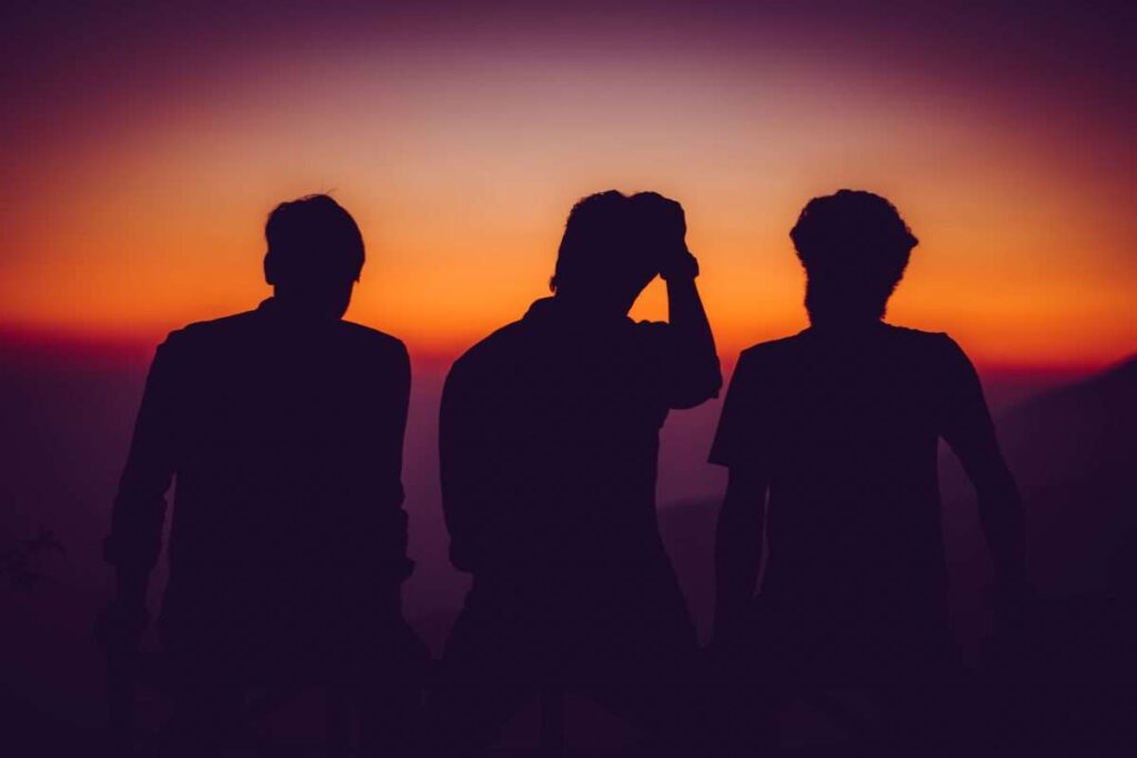 Boys in shadow against sunset