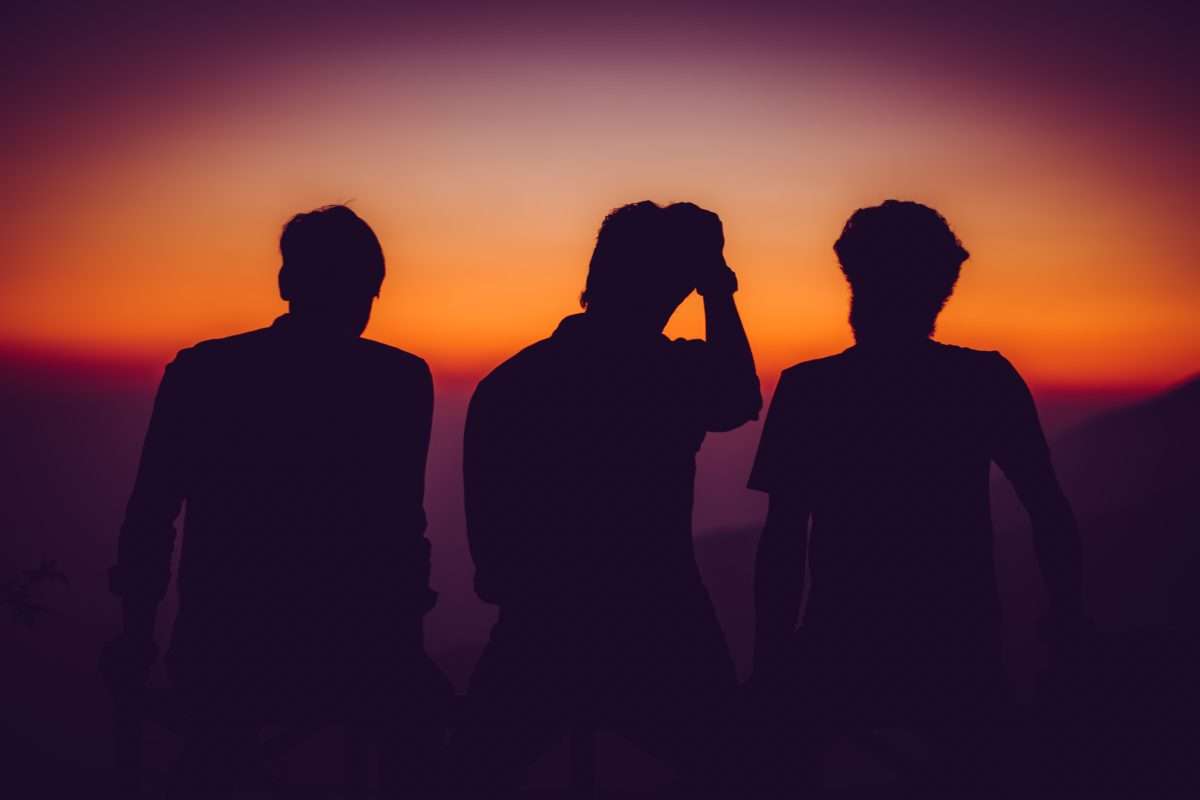 Boys in shadow against sunset