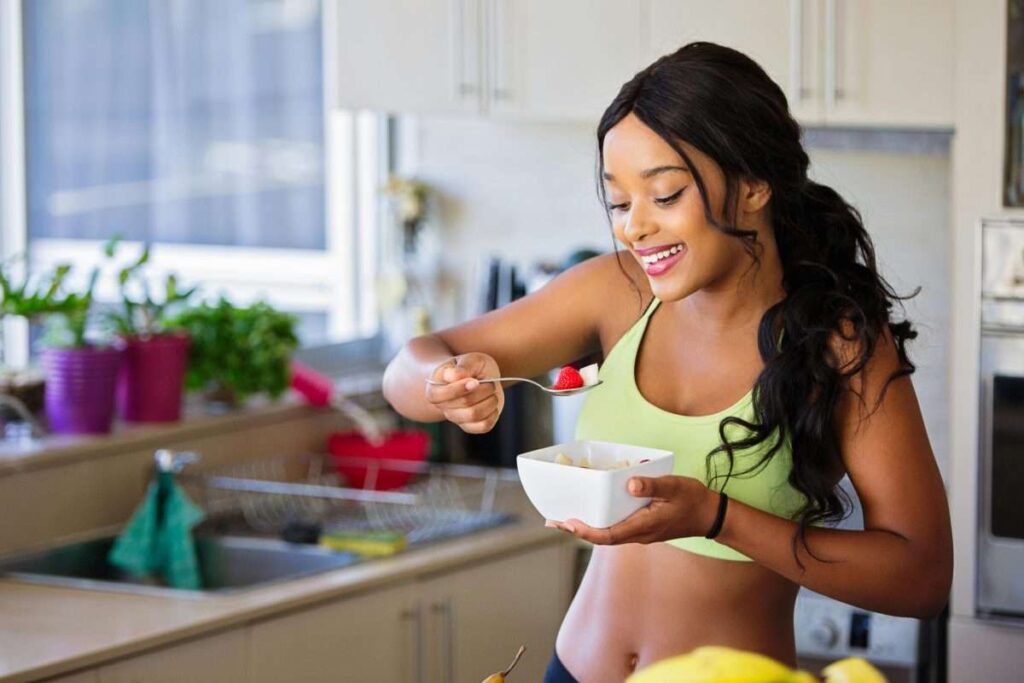 young adult girl with a bowl of fruit
