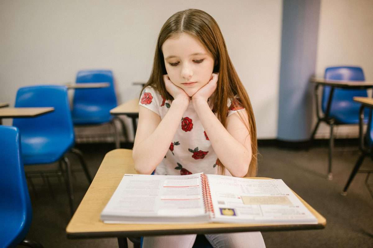 Girl at desk unhappy