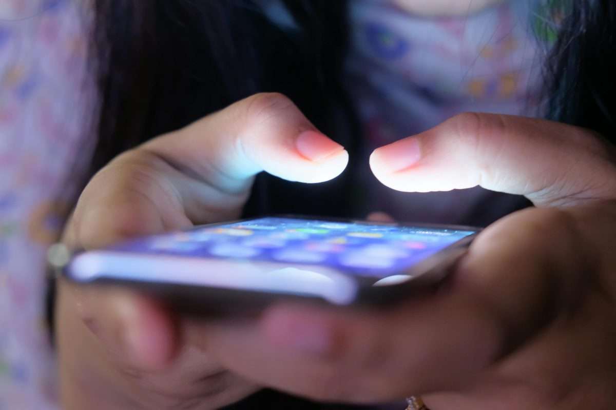 illuminated smartphone in girls' hands