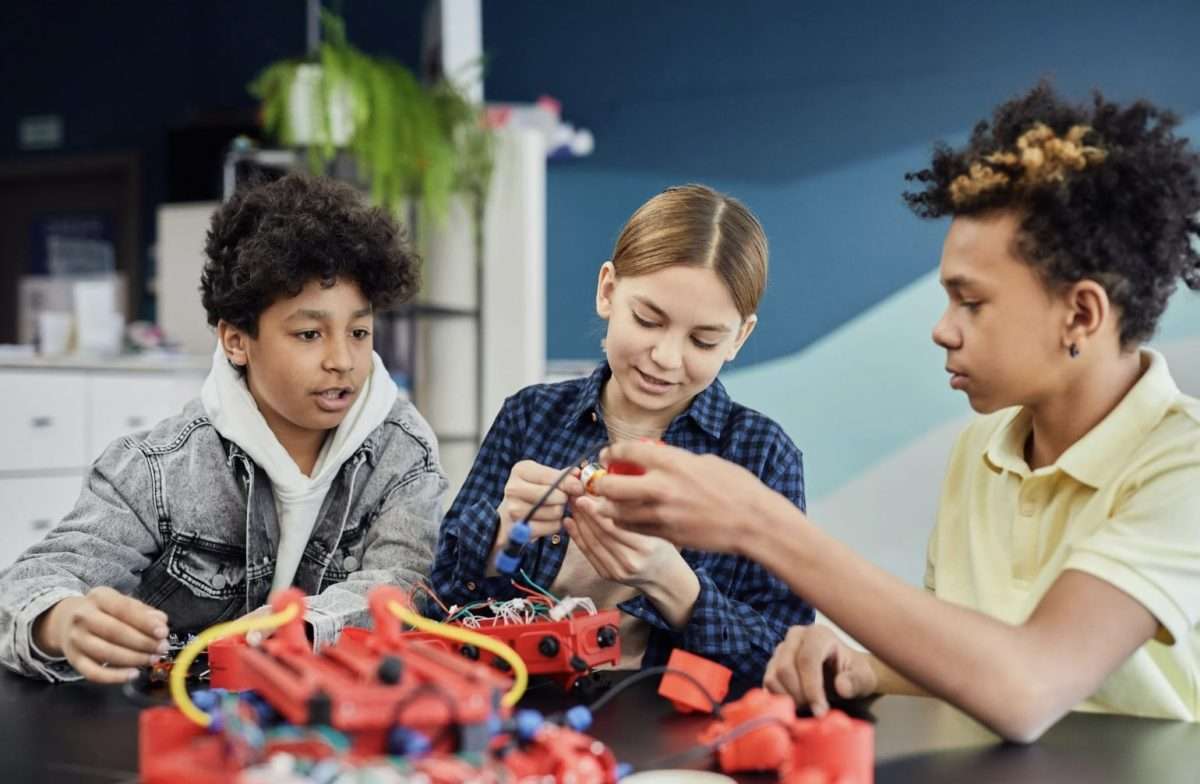Teens with building lego model