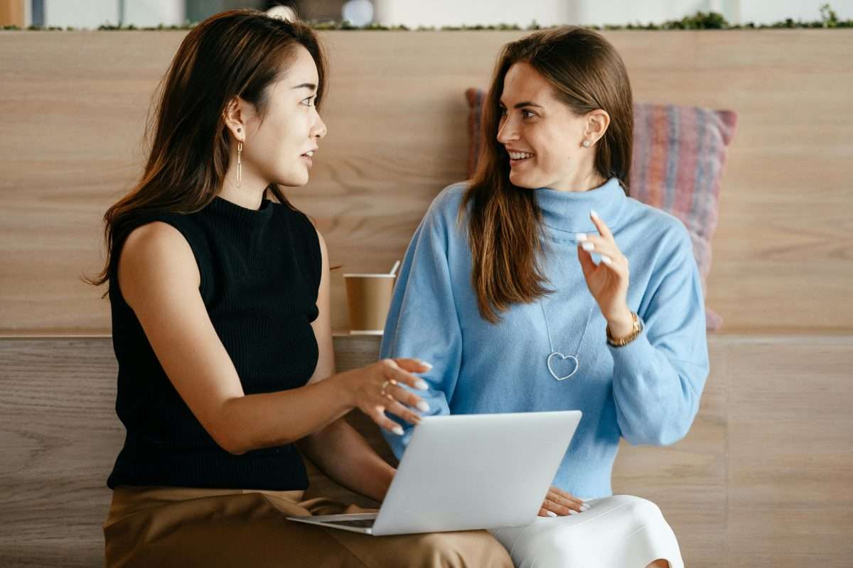 two women in discussion with laptop