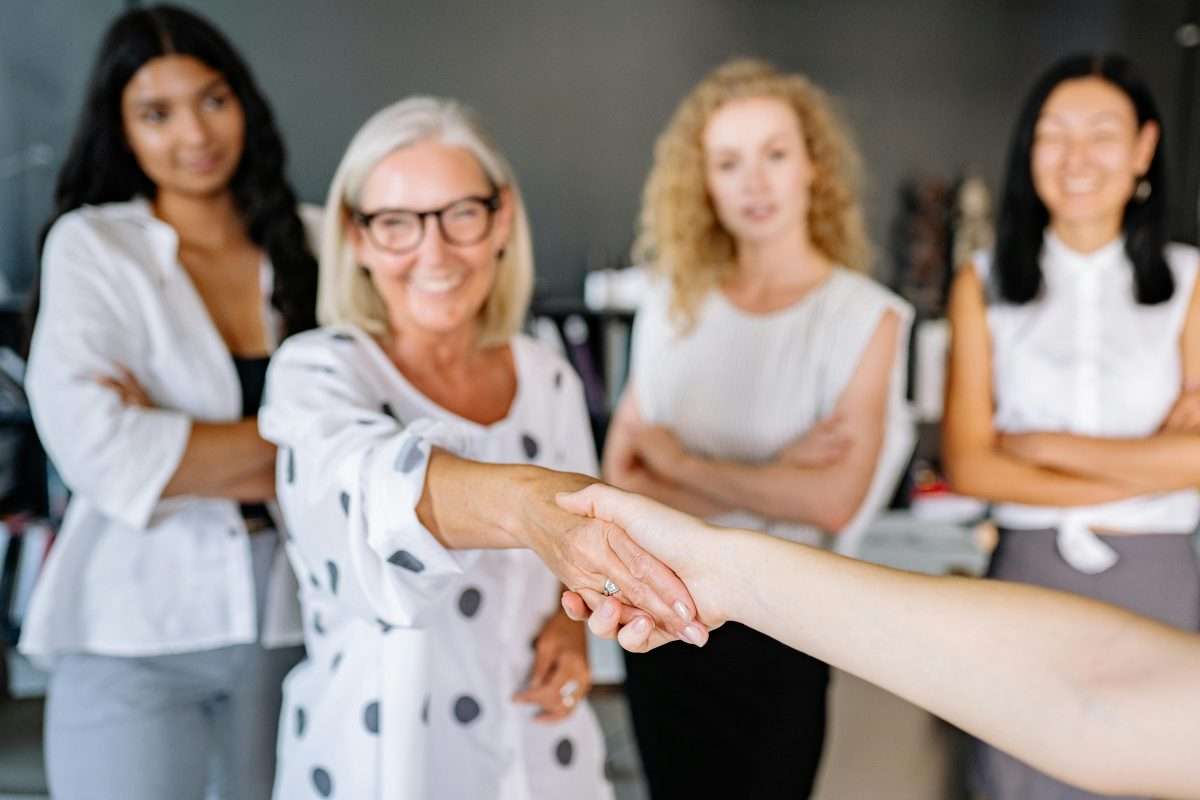group of women with one shaking hands