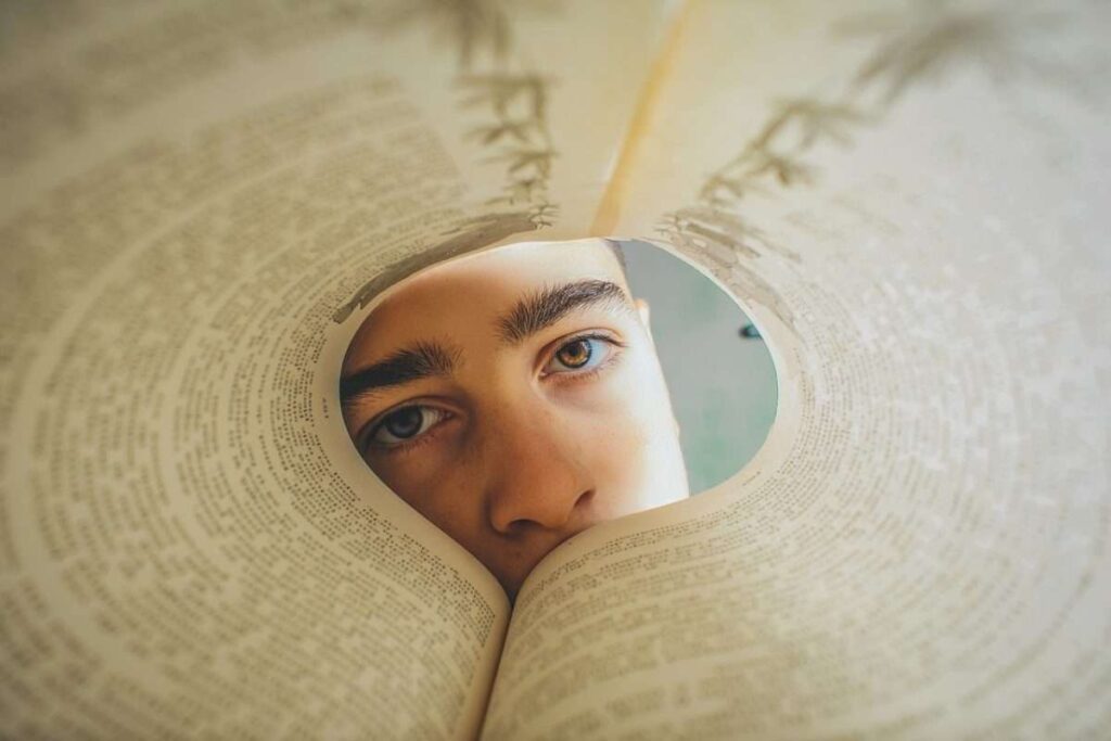 teen boy looking through book