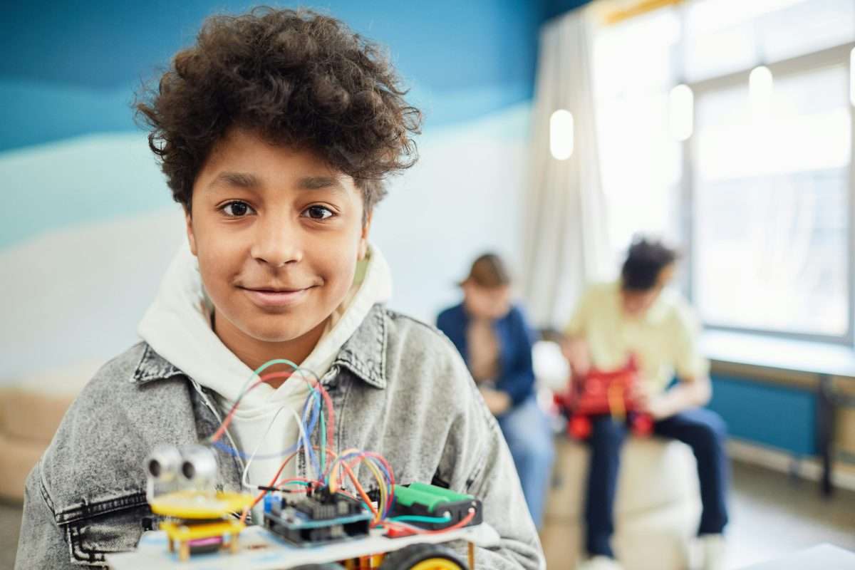 black boy smiling to camera with lego
