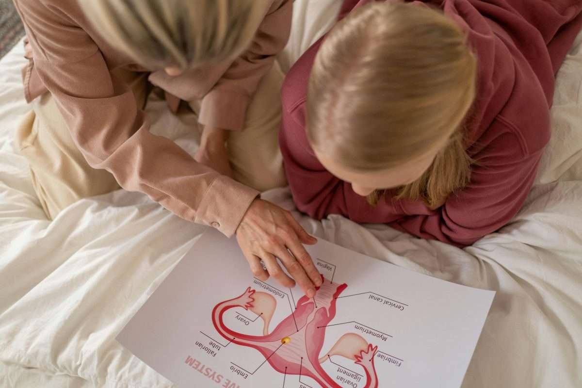 mother and daughter looking at anatomy page of book