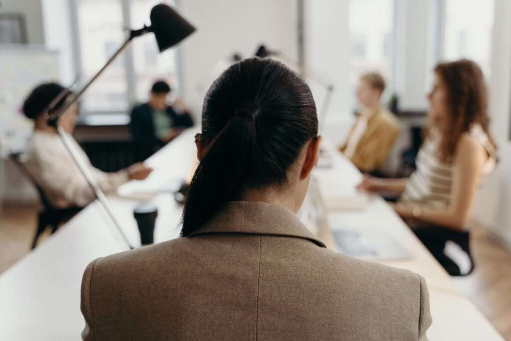 woman at head of the table in a boardroom