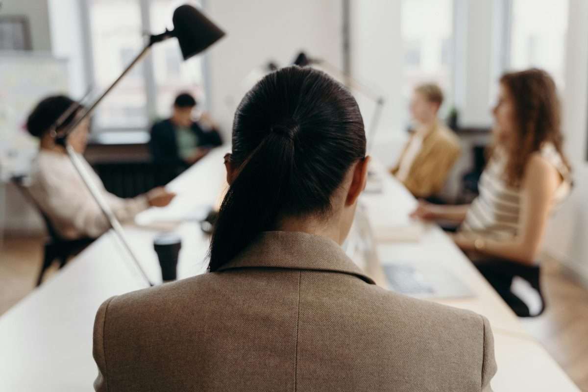woman at head of the table in a boardroom