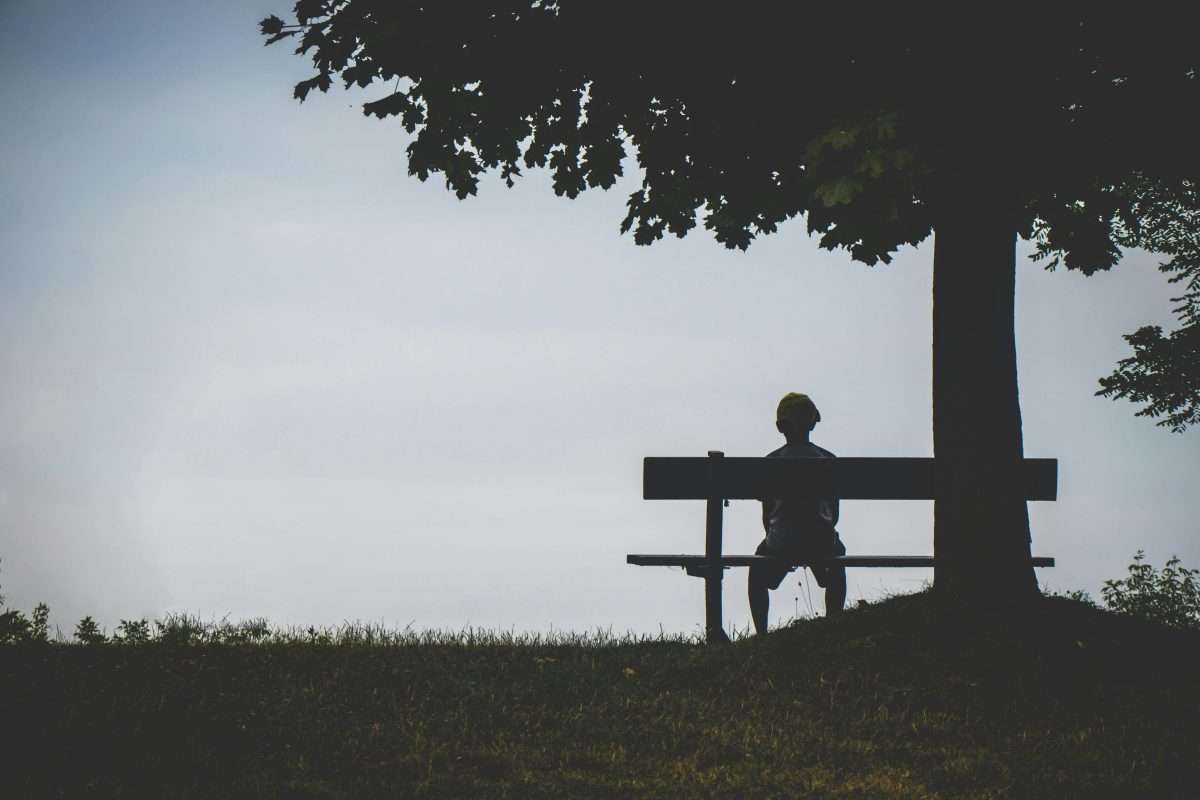 boy sitting on a bench