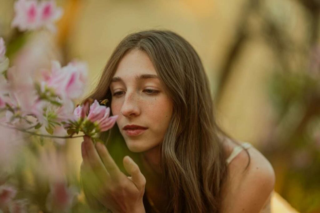 Woman Smelling Pink Flowers