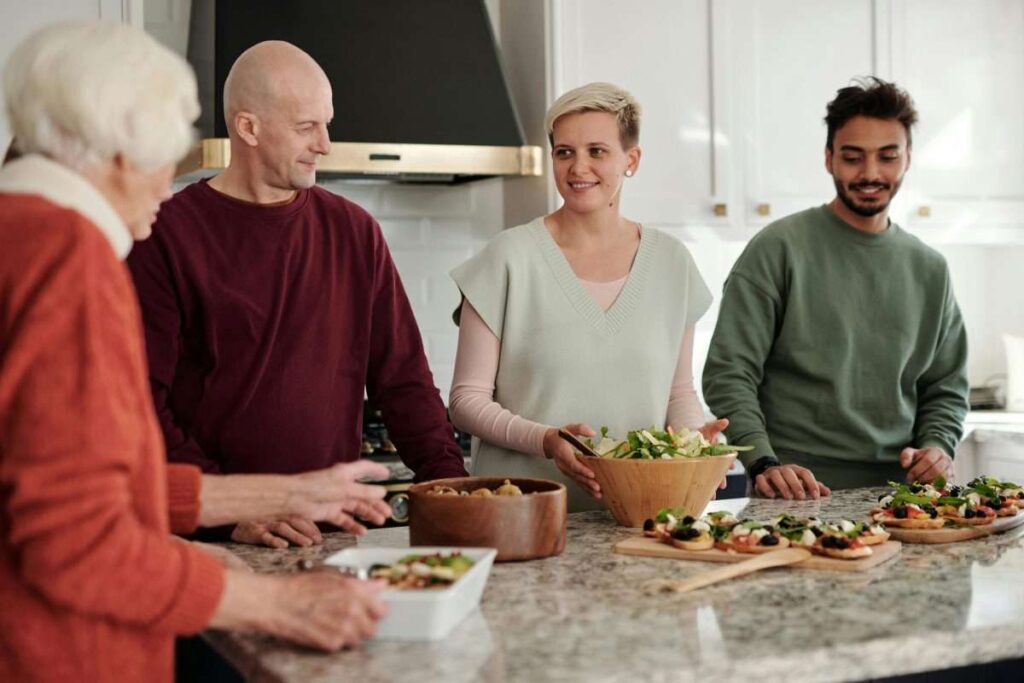 A Family Talking while Standing in the Kitchen